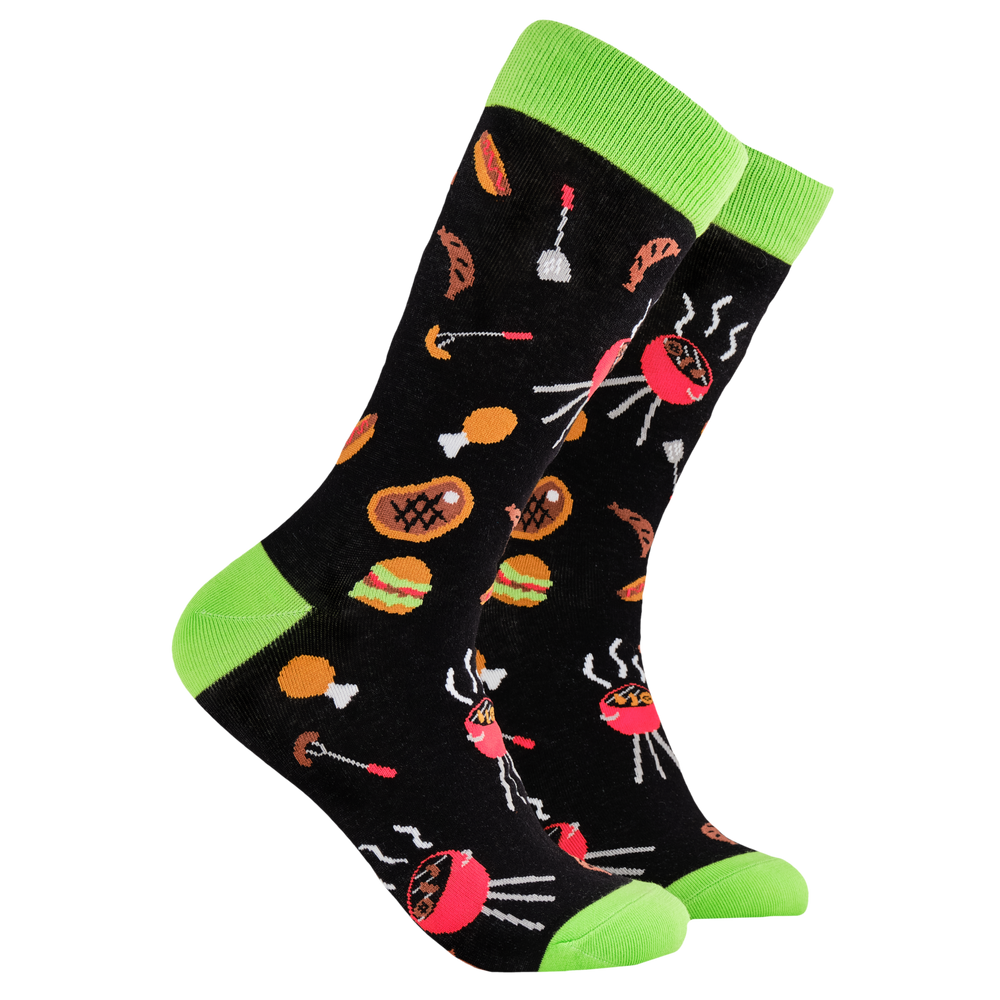 BBQ Socks - King of The Grill. A pair of socks depicting Meat and BBq tools. Black legs, green cuff, heel and toe.