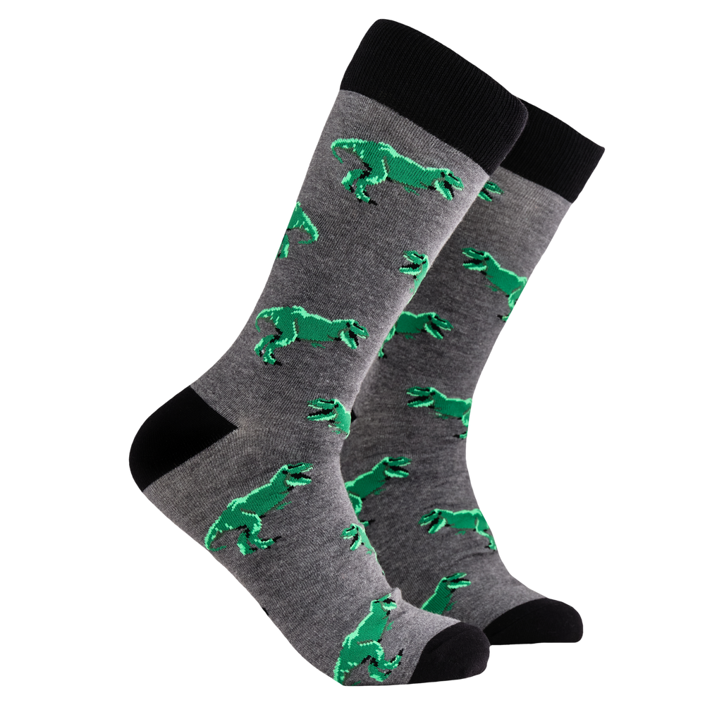 T-Rex Socks - King of The Lizards Socks. A pair of socks depicting T-Rex dinosaurs. Grey legs, black cuff, heel and toe.