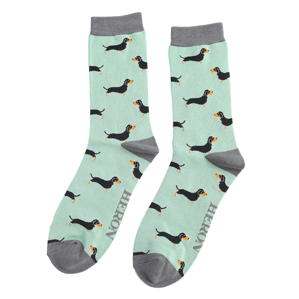 
                  
                    A pair of socks featuring a sausage dog pattern. Turquoise legs, grey cuffs, heel and toe.
                  
                