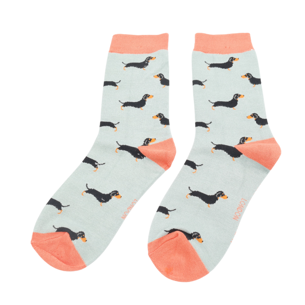 
                  
                    A pair of socks featuring a sausage dog pattern. Light blue legs, peach blue cuffs, heel and toe.
                  
                