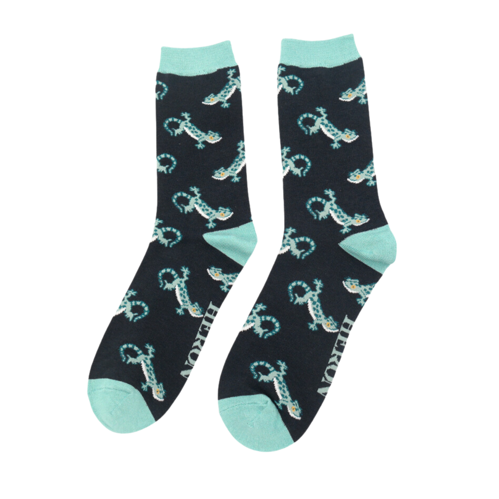 A pair of socks with a lizard pattern. dark green legs, turquoise heel, cuff and toe.