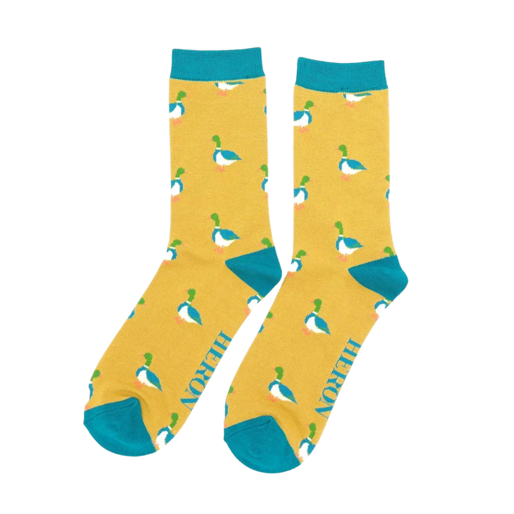 A pair of socks with a pattern of ducks. yellow legs, teal cuff, toe and heel.