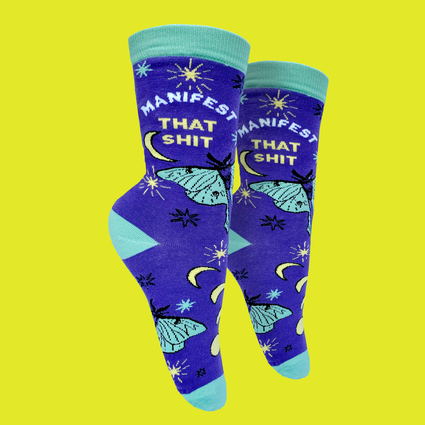 
                  
                    A pair of socks with the slogan Manifest That S**t and a butterfly motif. Purple ankles, turquoise toe, heel and cuff.
                  
                