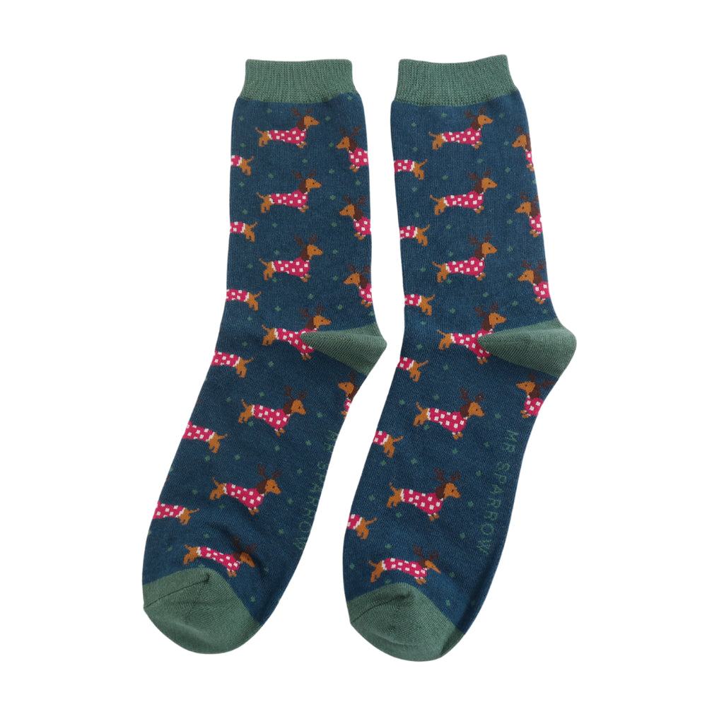 
                      
                        A pair of socks with a festive sausage dog pattern. Dark blue legs, dark green heel, toe and cuff. 
                      
                    