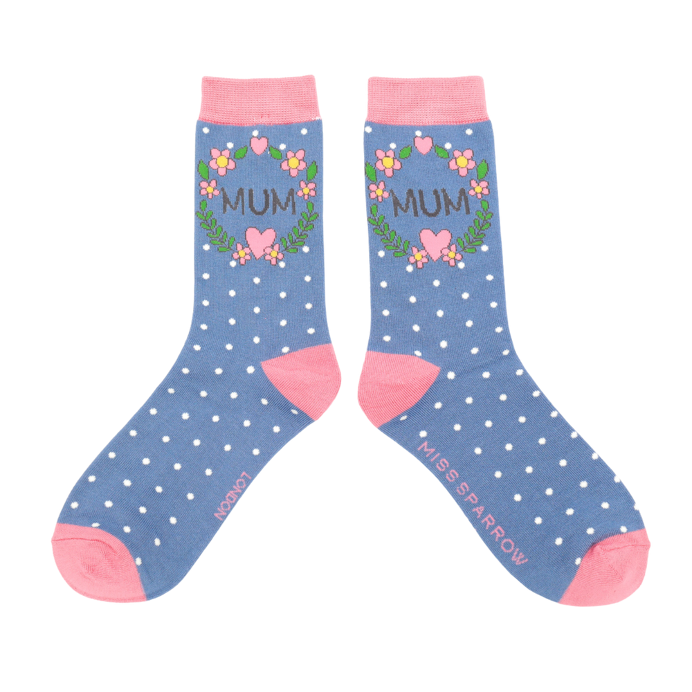 
                      
                        A pair of socks with a floral wreath Mum motif. Blue legs, light pink cuff, heel and toe.
                      
                    