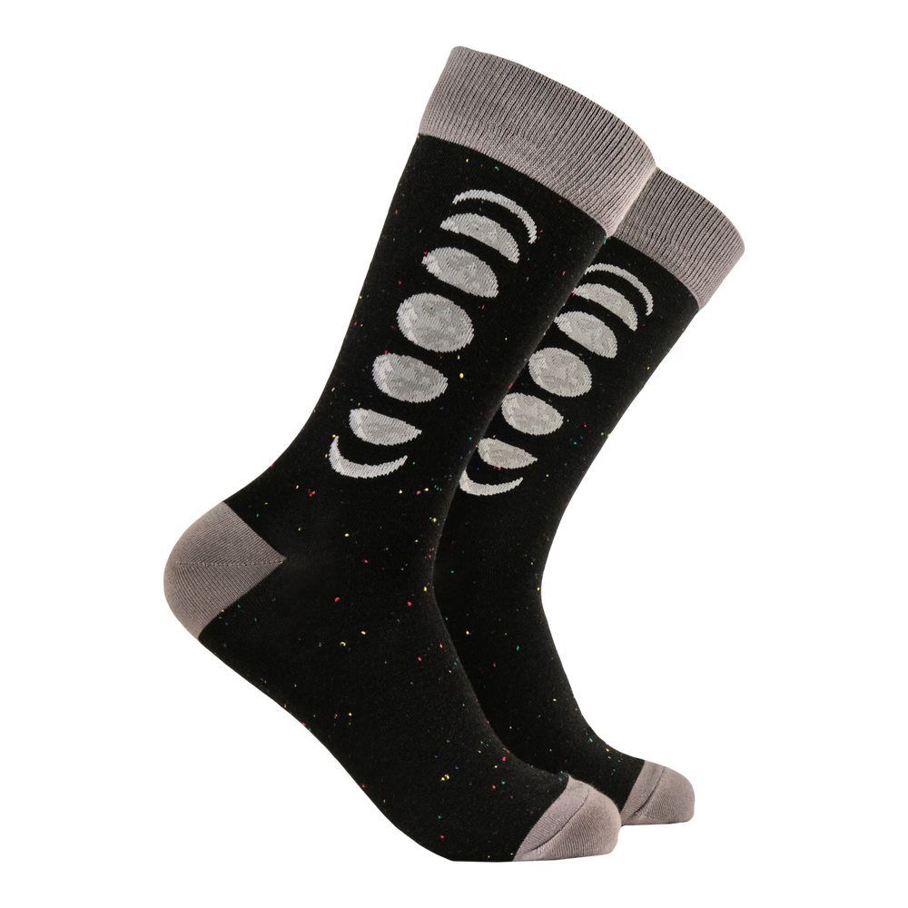 Moon Phases Socks. A pair of socks featuring the phases of the moon. Black legs, grey heel, toe and cuff. 