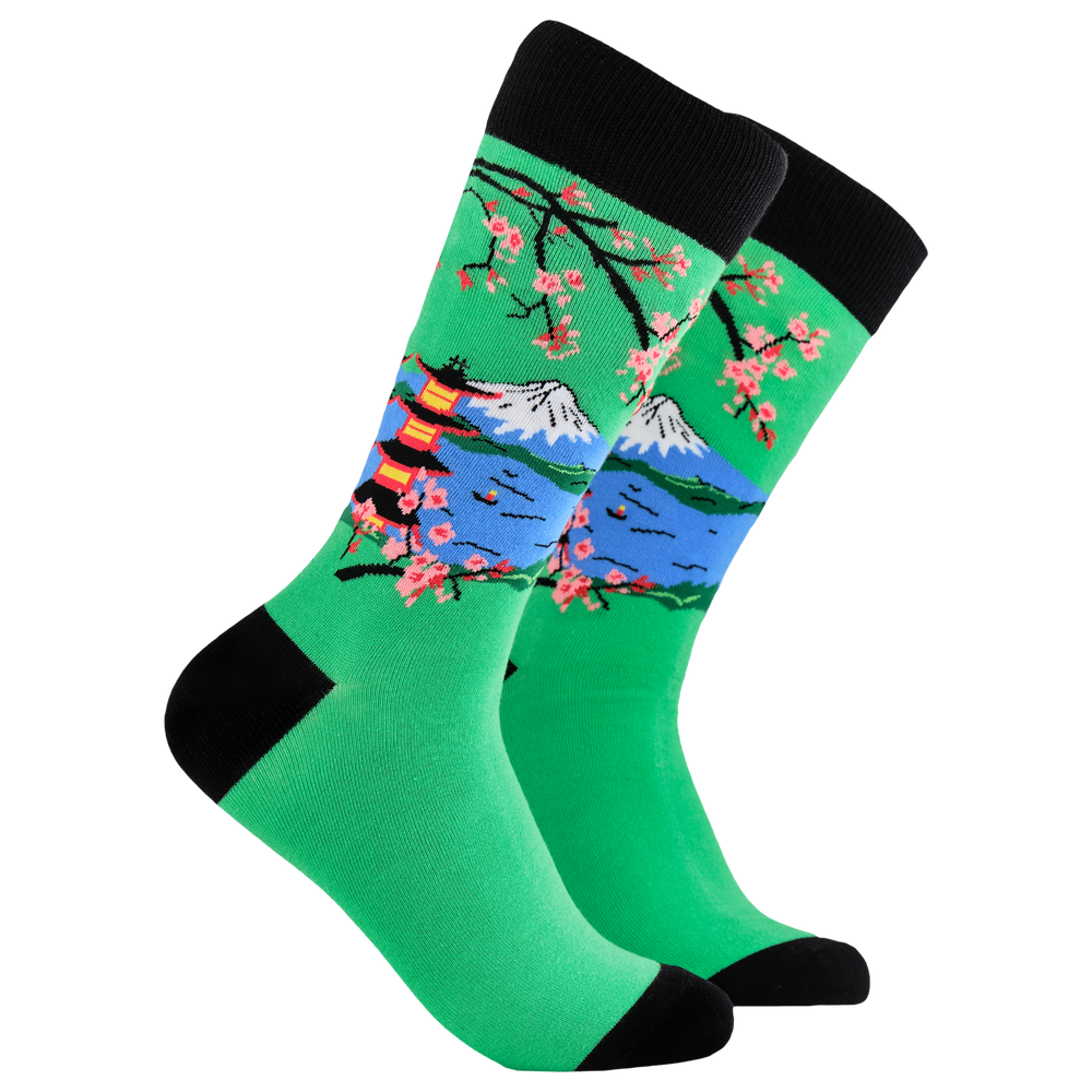 Japanese Socks - Mount Fuji. A pair of socks depicting mount fuji and cherry blossom. Green legs, black cuff, heel and toe.