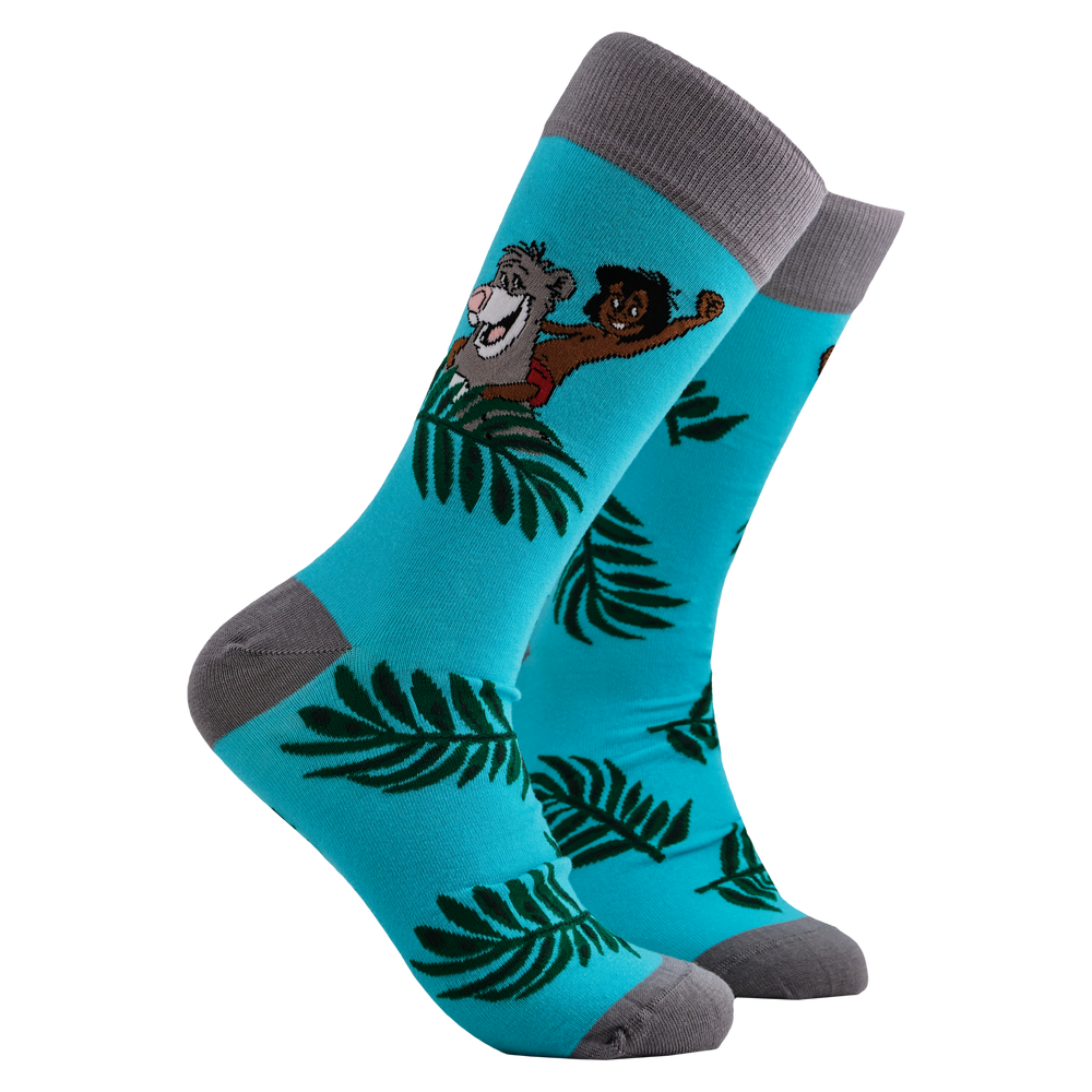 
                      
                        Disney's Jungle Book Socks - Mowgli and Baloo. A pair of socks depicting Mowglie and Baloo playing in the jungle. Turquoise legs, grey toes, heel and cuff. 
                      
                    