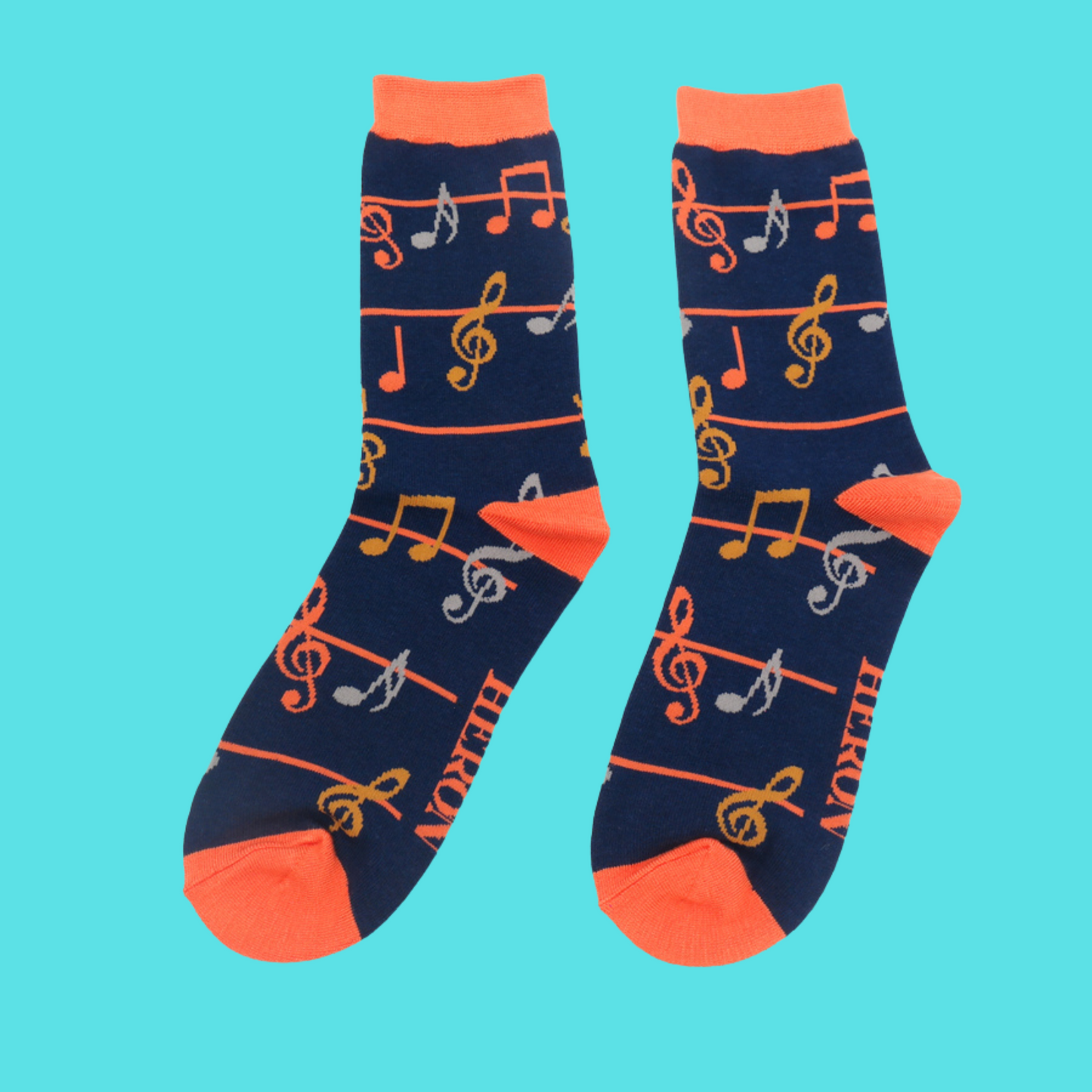 
                  
                    A pair of socks with a music note pattern. Dark Blue legs, orange cuffs, heel and toe.
                  
                