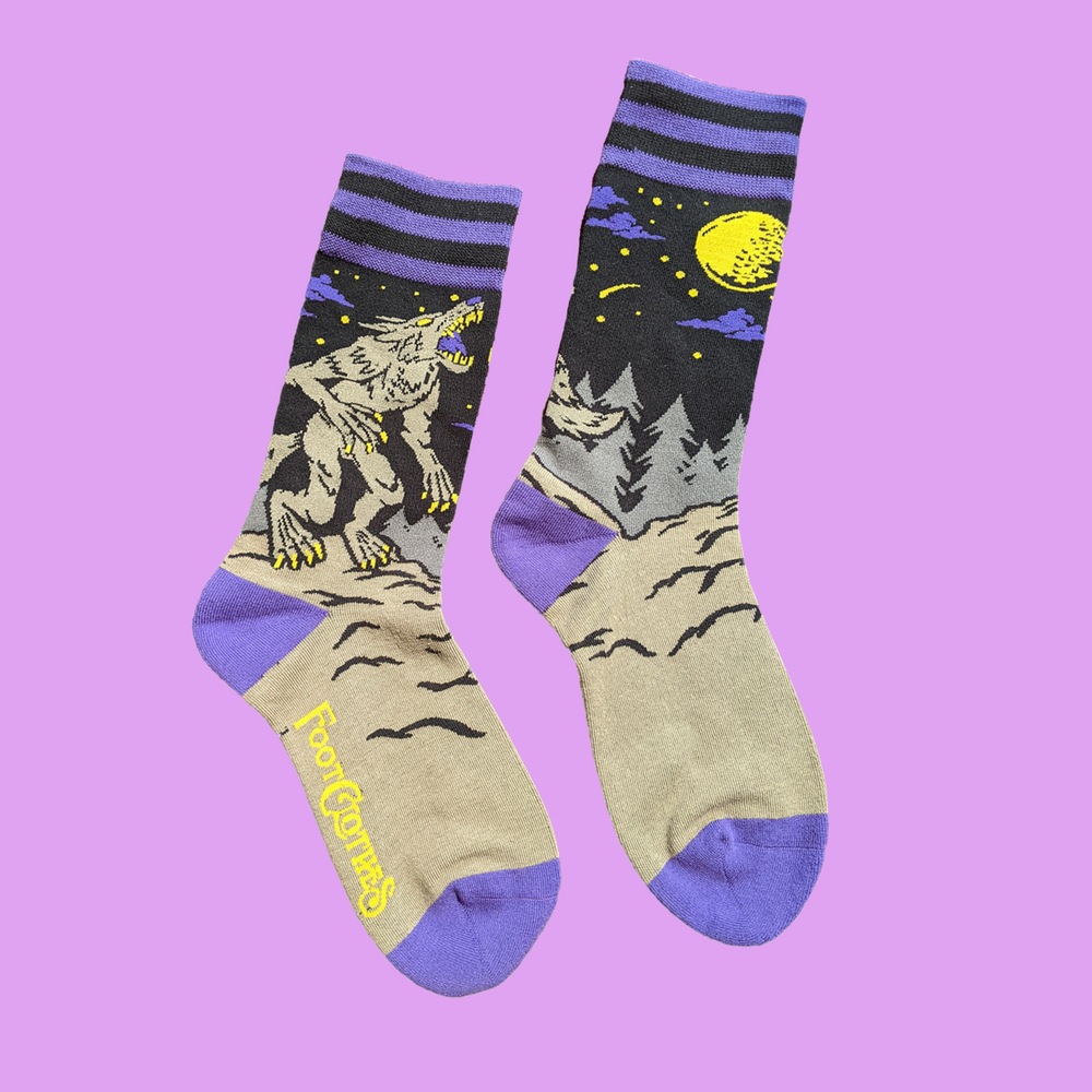 
                      
                        A pair of socks featuring an evil werewolf design. Grey legs, purple heel, toe and cuff. 
                      
                    