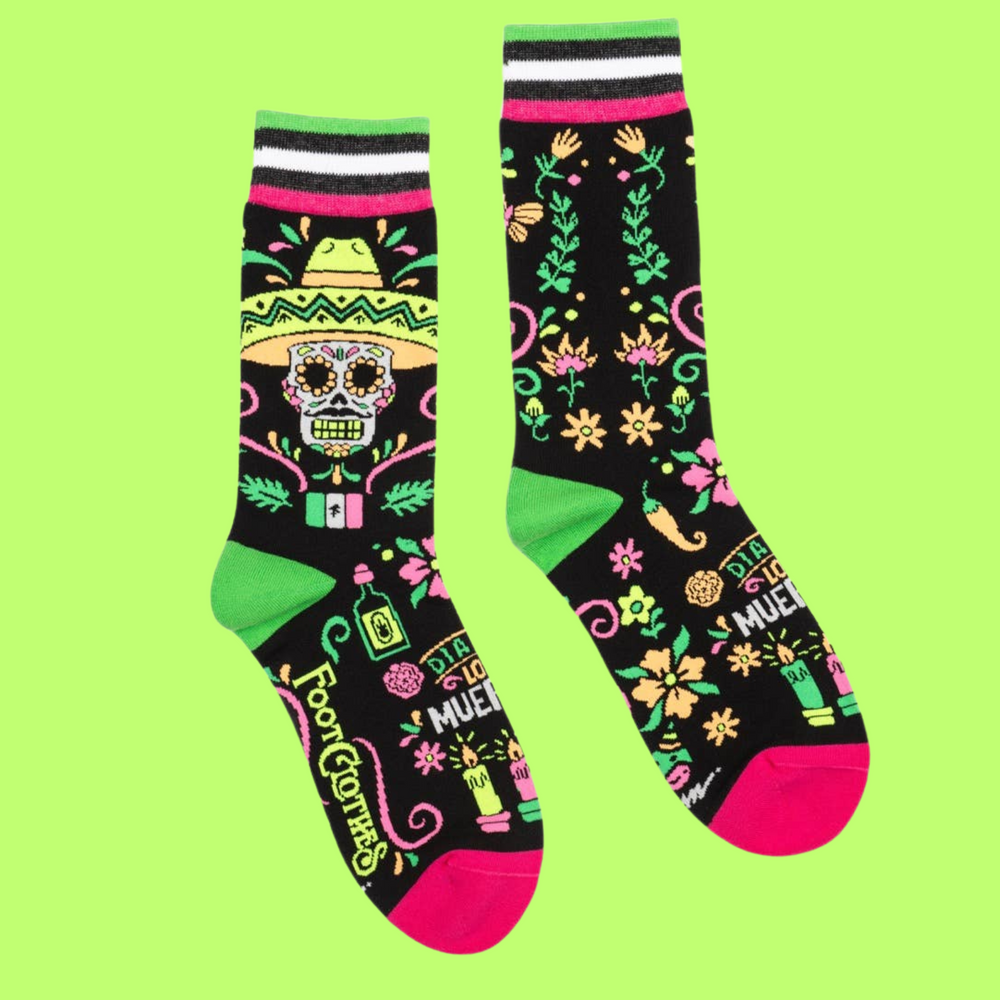 
                      
                        A pair of socks with a day of the dead motif. Black legs, pink and green heel, toe and cuff. 
                      
                    