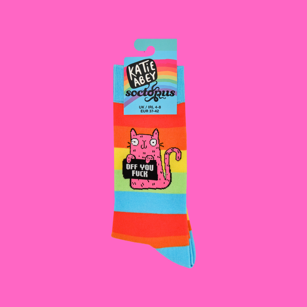 
                      
                        A pair of socks featuring a cute cat holding a sweary sign. Rainbow legs. 
                      
                    