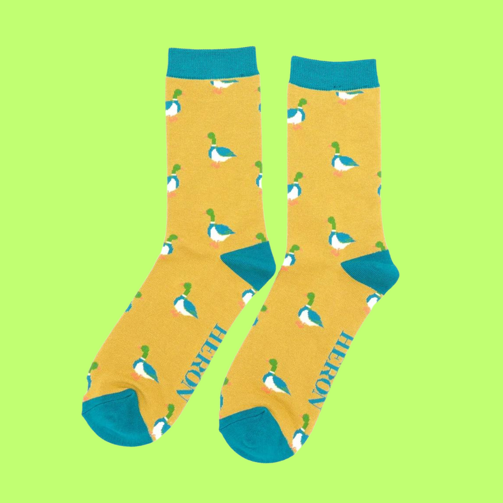 
                  
                    A pair of socks with a pattern of ducks. yellow legs, teal cuff, toe and heel.
                  
                