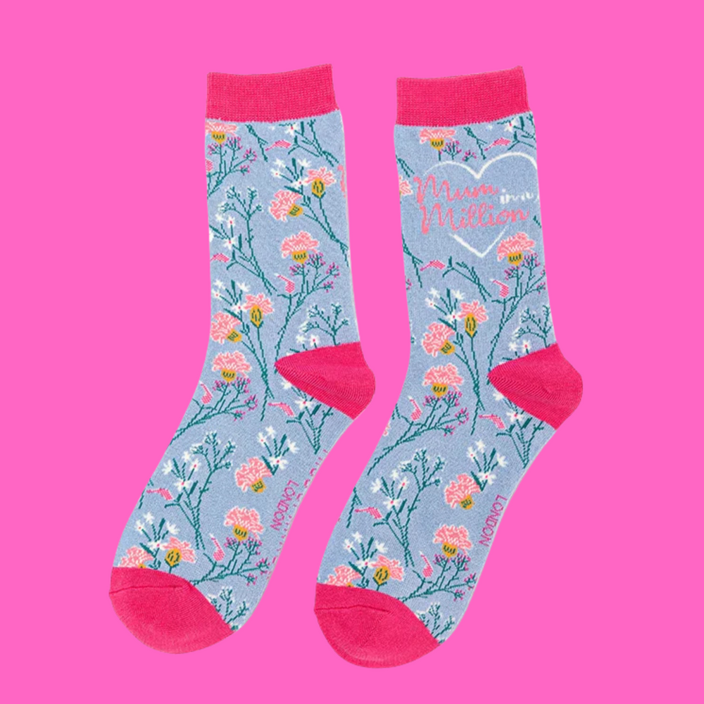 
                      
                        A pair of socks with a floral motif and a mum in a millions slogan. Blue legs, pink heel, toe and cuff. 
                      
                    