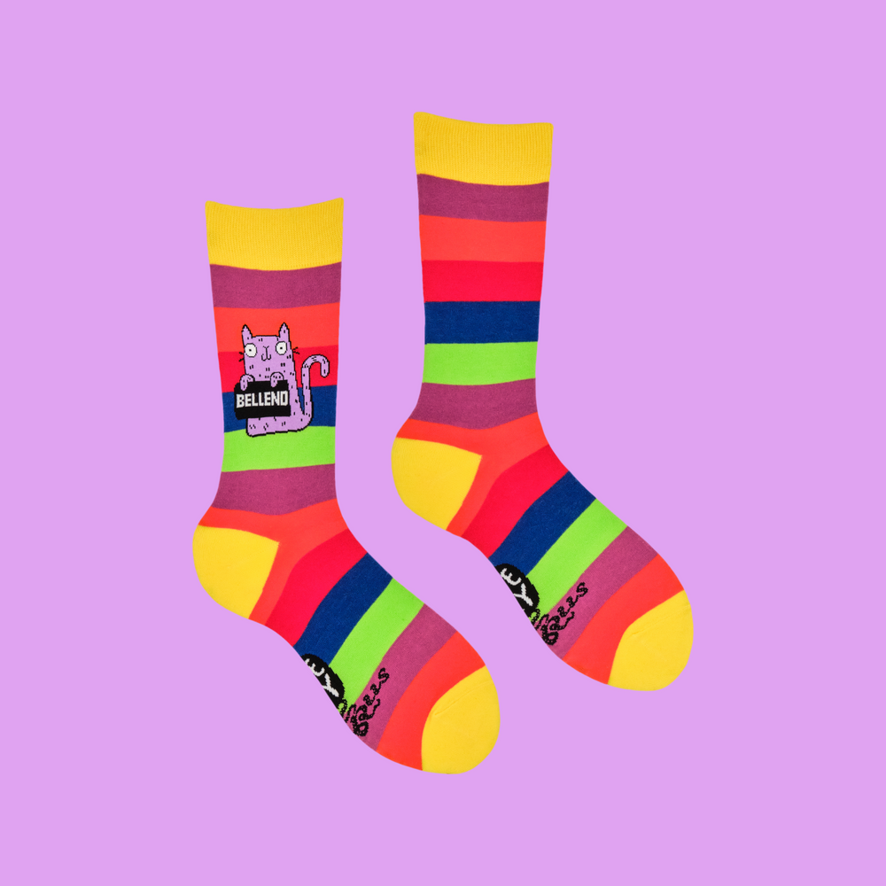 A pair of socks designed by artist Katy Abey,  featuring a cat holding a sign that says Bellend. 