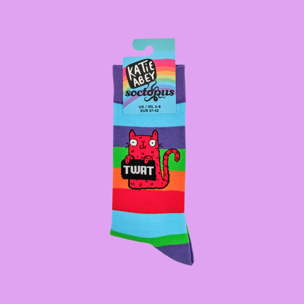 
                      
                        A pair of socks featuring a cute cat holding a sweary sign. Rainbow legs. 
                      
                    