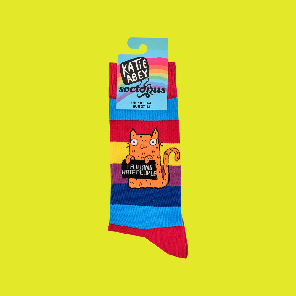 
                      
                        A pair of socks featuring a cute cat holding a sweary sign. Rainbow striped legs. 
                      
                    