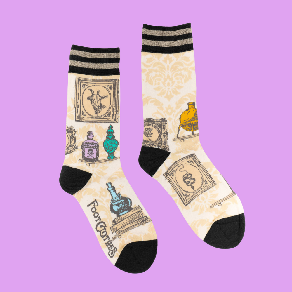 
                      
                        A pair of socks featuring antique curiosities. Cream legs, black heel, toe and cuff. 
                      
                    