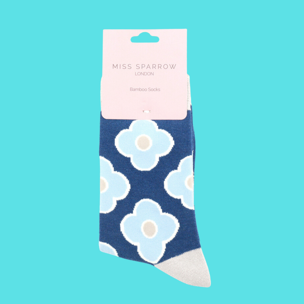 
                      
                        A pair of socks depicting a retro flower pattern. Blue legs, cream heel, toe and cuff.
                      
                    