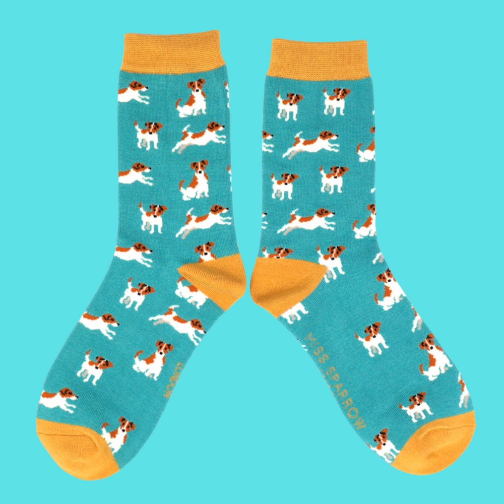 
                      
                        A pair of socks featuring a jack russell motif. Teal legs, orange heel, toe and cuff. 
                      
                    