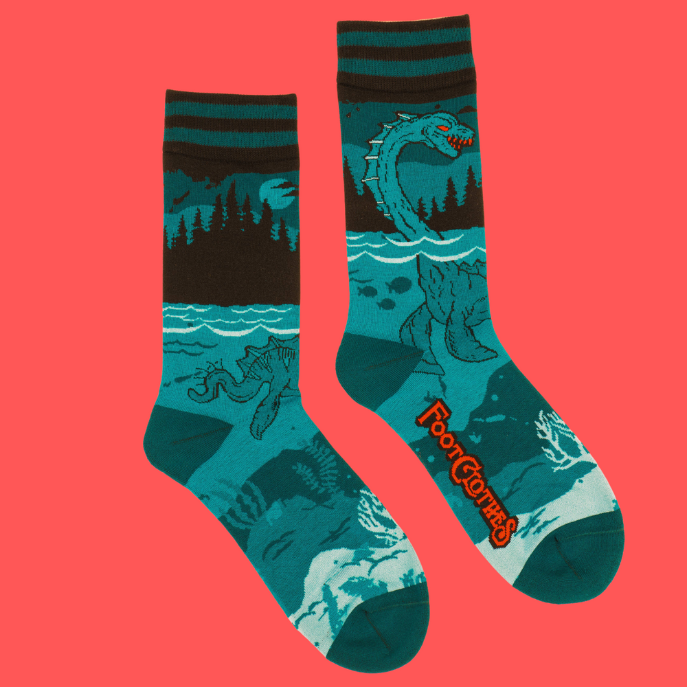 
                      
                        A pair of socks featuring the Loch Ness Monster. Blue legs, blue heel, toe and cuff. 
                      
                    