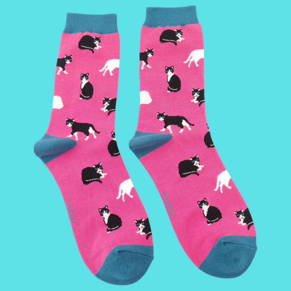 
                      
                        A pair of socks featuring black and white cats. Pink legs, blue heel, toe and cuff. 
                      
                    