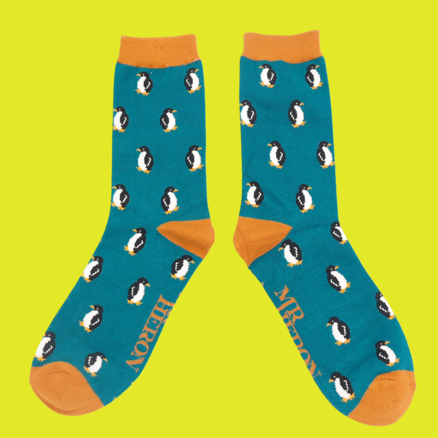 
                  
                    A pair of socks with a penguin pattern. Teal legs, orange heel, cuff and toe.
                  
                