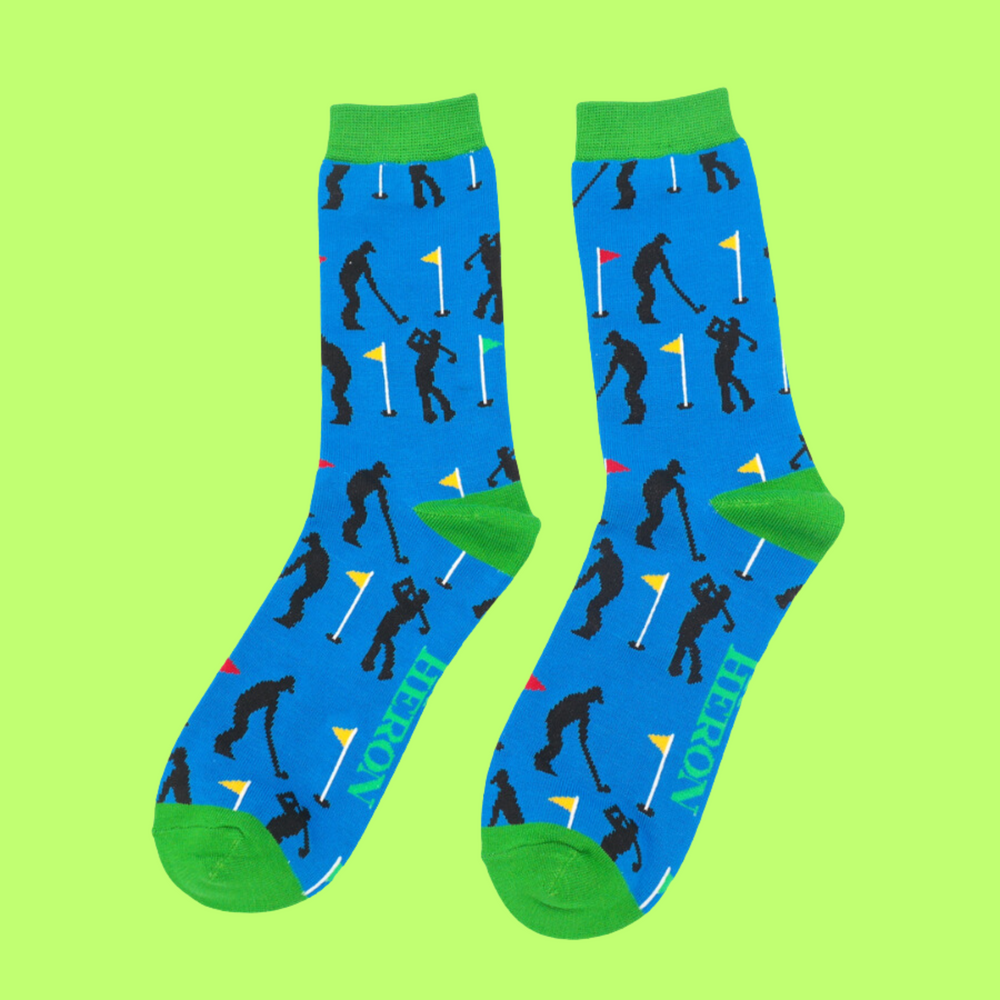 A pair of socks depicting golfers. Blue legs, bright green heel, toe and cuff.