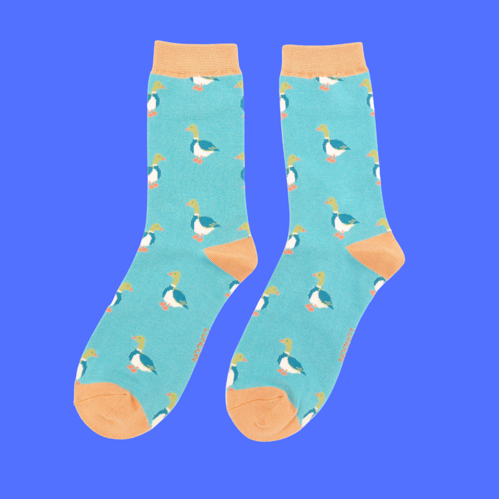 
                  
                    A pair of socks with a pattern of ducks. Teal legs, orange cuff, toe and heel.
                  
                