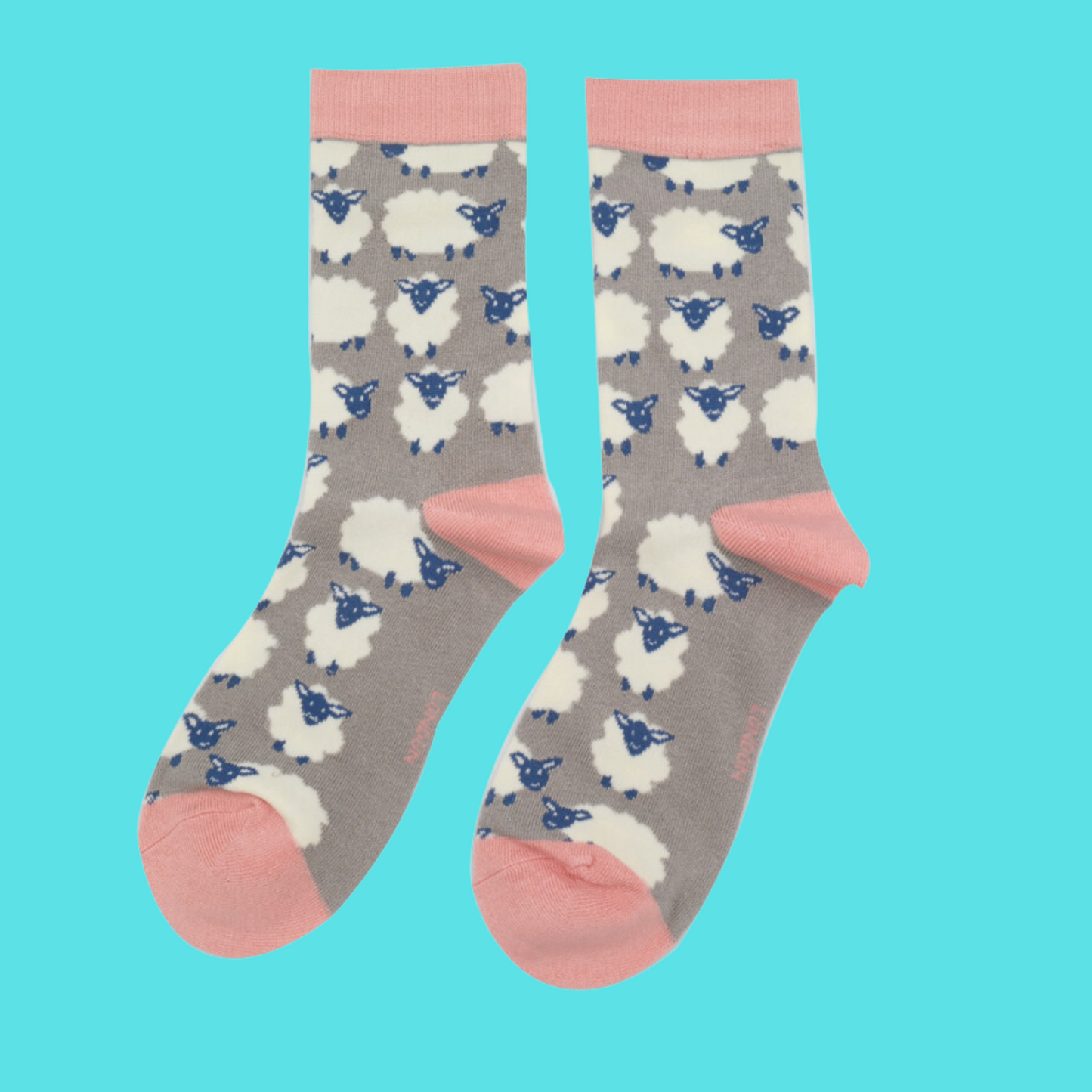 
                  
                    A pair of socks depicting happy sheep. Grey legs, pink heel, toe and cuff.
                  
                