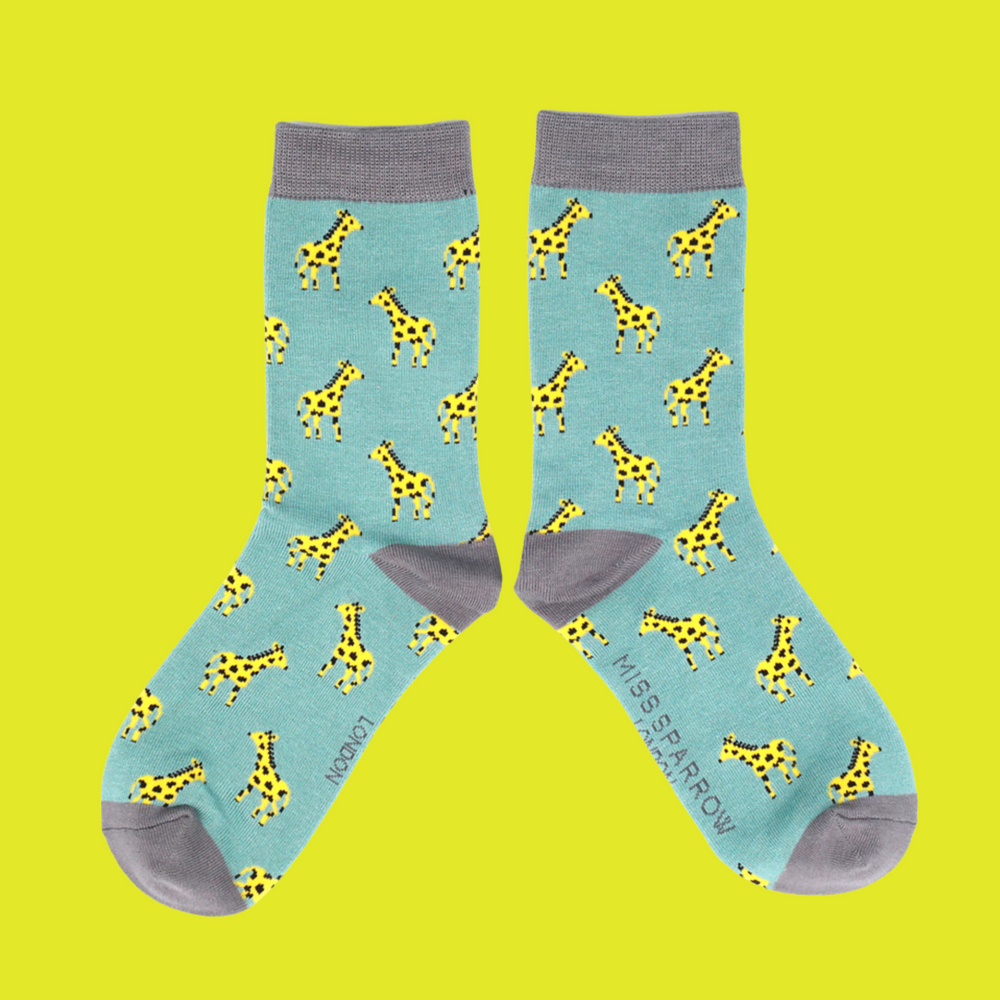 
                  
                    A pair of socks depicting giraffes. Teal legs, grey cuffs, toes, and heels.
                  
                