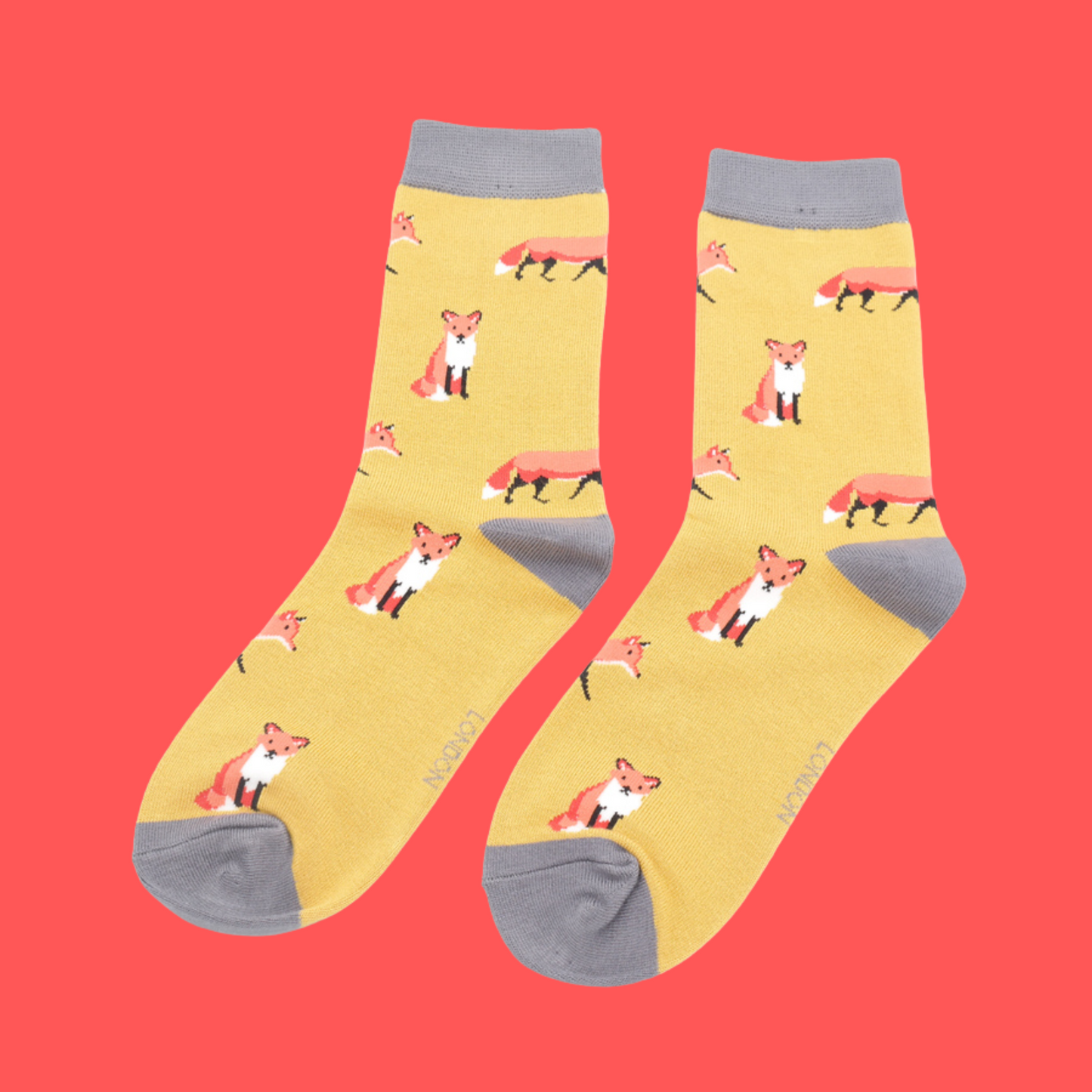 
                  
                    A pair of socks featuring a cute fox design. Yellow legs, grey cuff, heel and toe.
                  
                