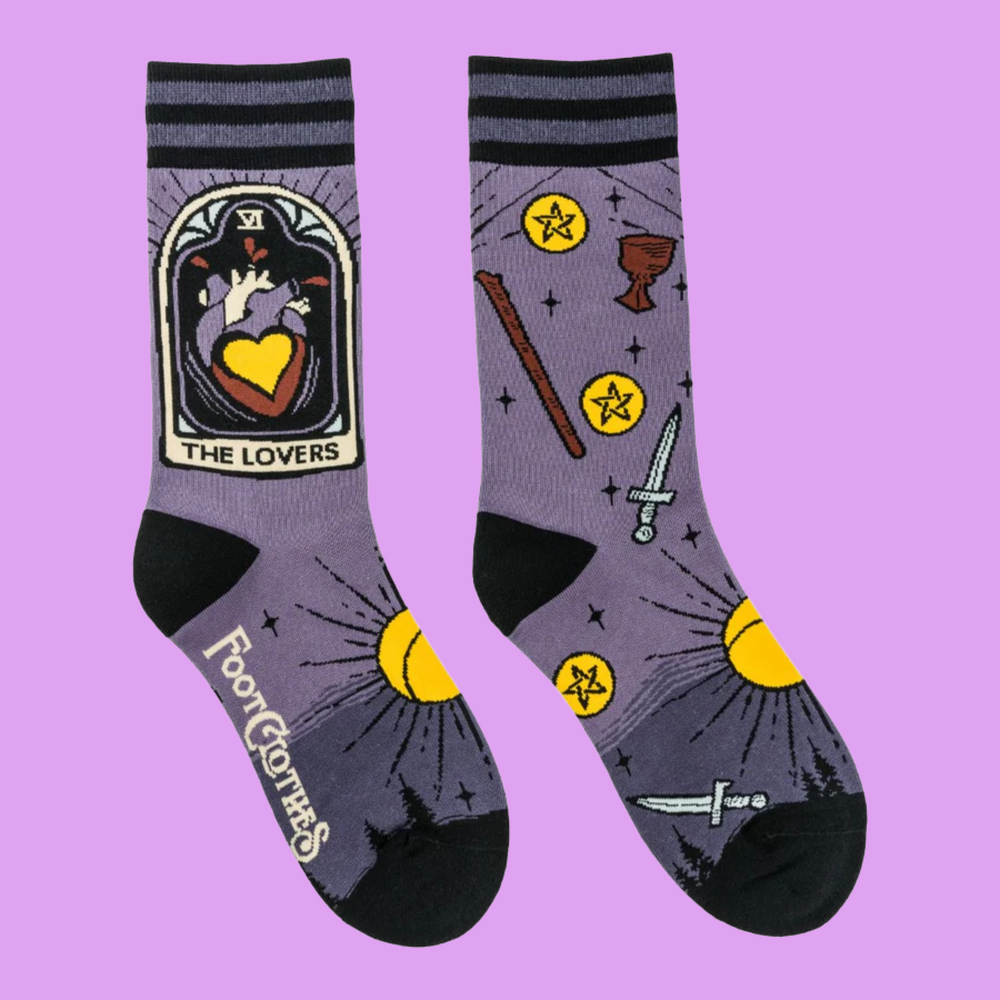 
                      
                        A pair of socks depicting the lovers tarot card and tarot symbols. Purple legs, black heel toe and cuff. 
                      
                    