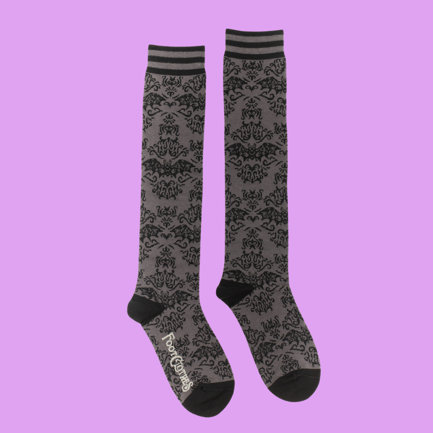 A pair of knee high socks with a bat and damask pattern. Grey legs, black, heel, toe and cuff. 