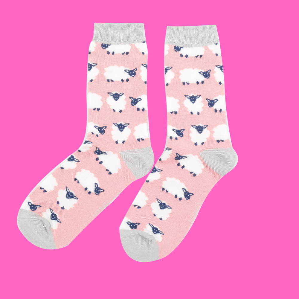 
                  
                    A pair of socks depicting happy sheep. Pink legs, grey heel, toe and cuff.
                  
                