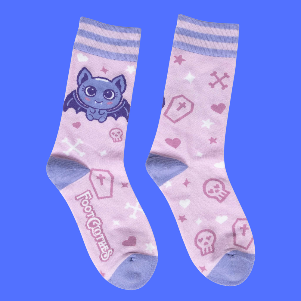 
                      
                        A pair of socks with a cute bat motif. Pink legs, light purple heel, toe and cuff. 
                      
                    