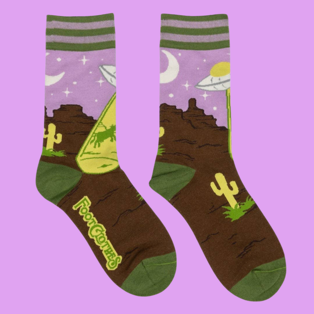 
                      
                        A pair of socks featuring a UFO and a very confused cow. Brown legs, green heel, toe and cuff. 
                      
                    