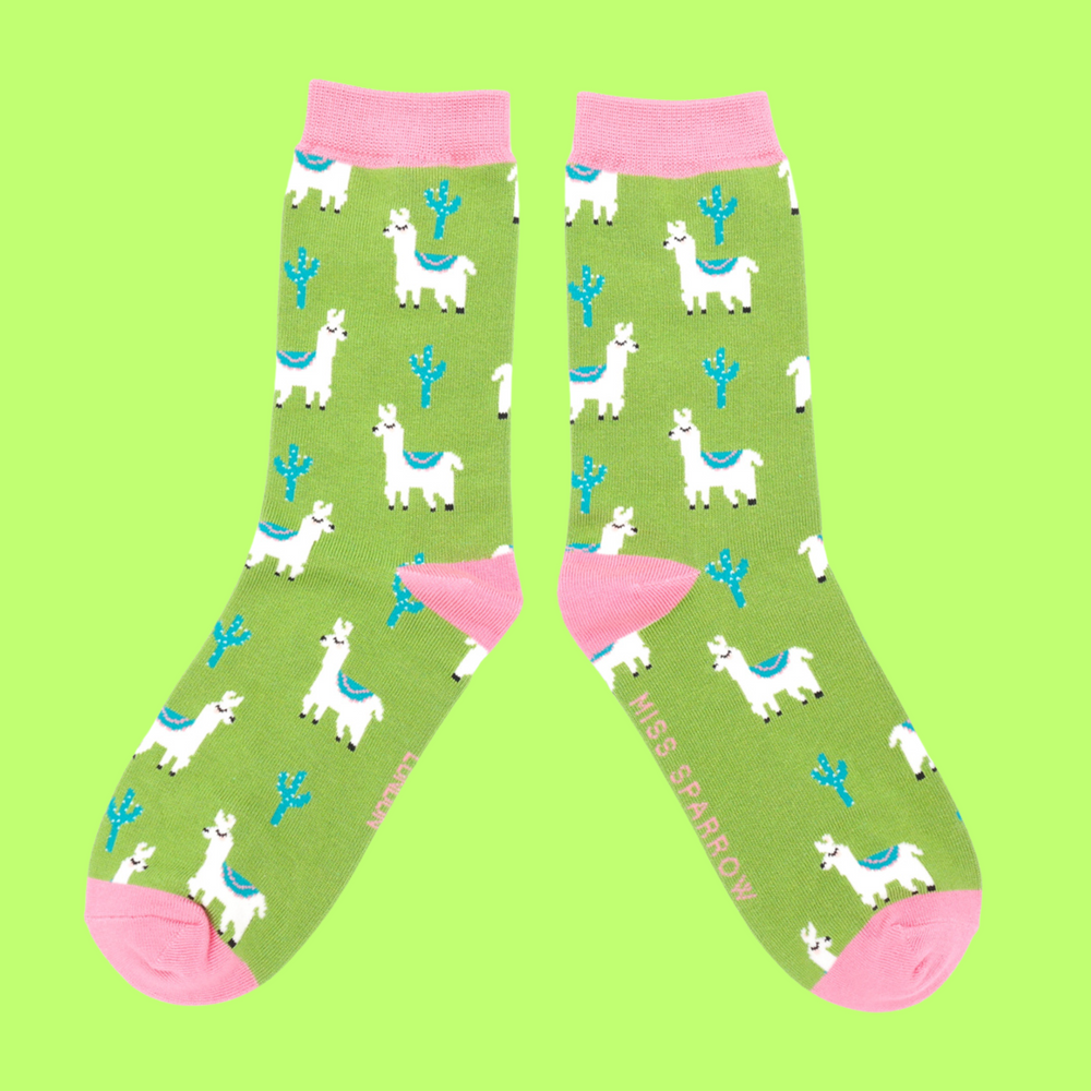 
                  
                    A pair of socks depicting cacti and Llamas. Green legs, pink cuff, heel and toe.
                  
                