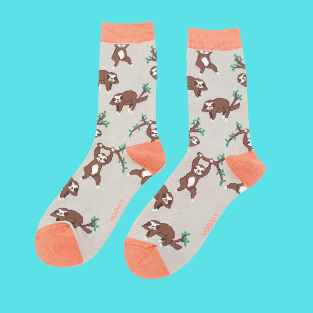 
                  
                    A pair of socks depicting sloths having fun. Grey legs, peach cuff, toe and heel.
                  
                