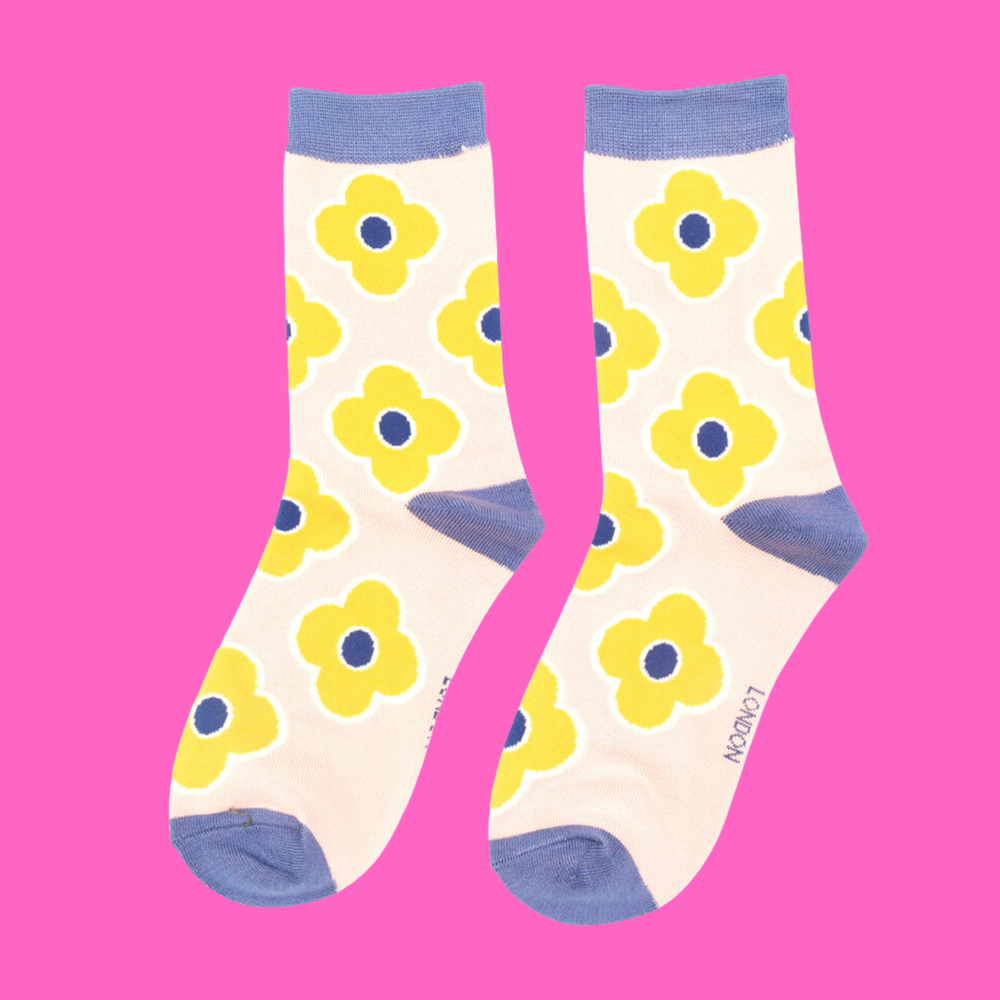 
                  
                    A pair of socks depicting a retro flower pattern. Cream legs, light blue heel, toe and cuff.
                  
                