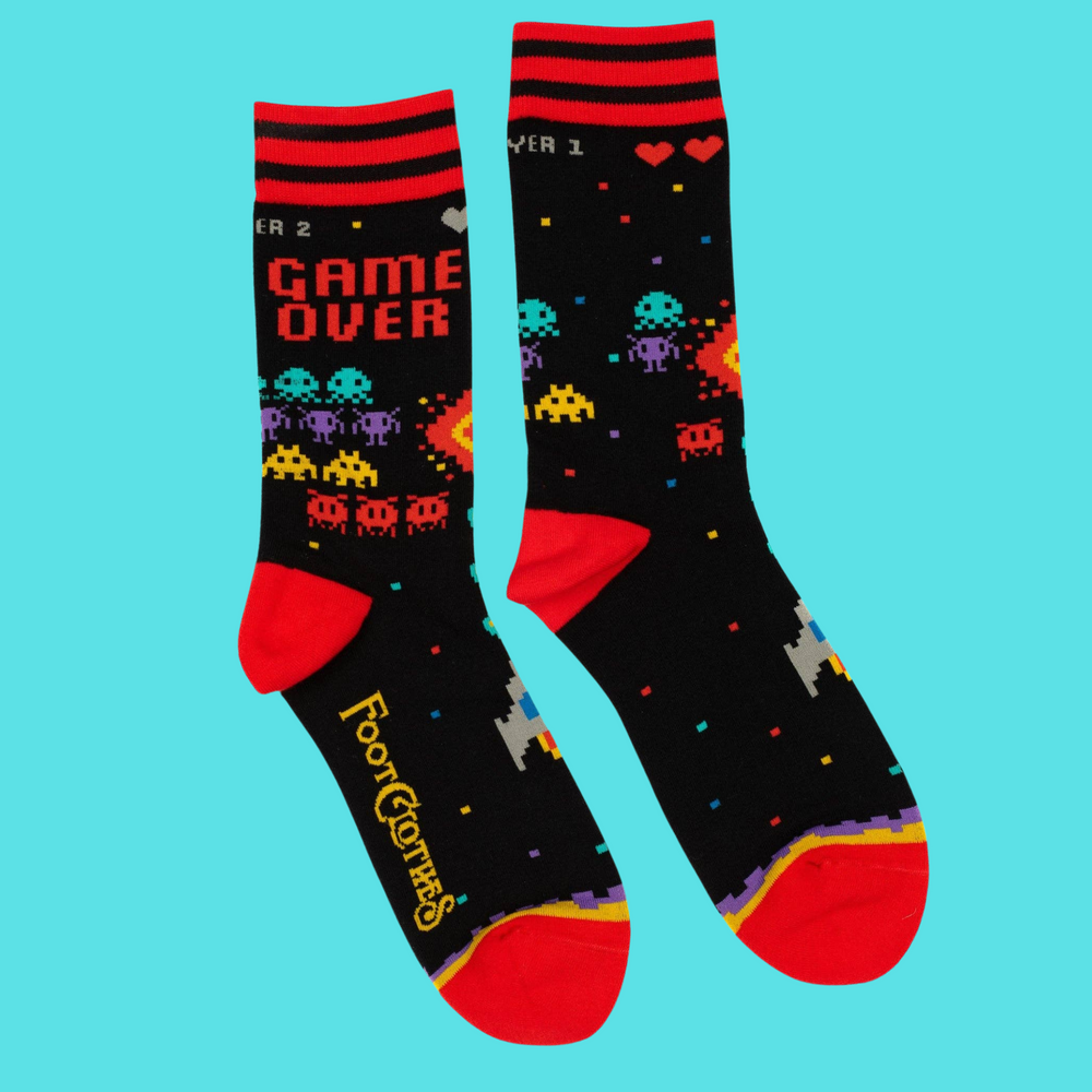 
                      
                        A pair of socks featuring space invaders and game over. Black legs, red heel, toe and cuff. 
                      
                    