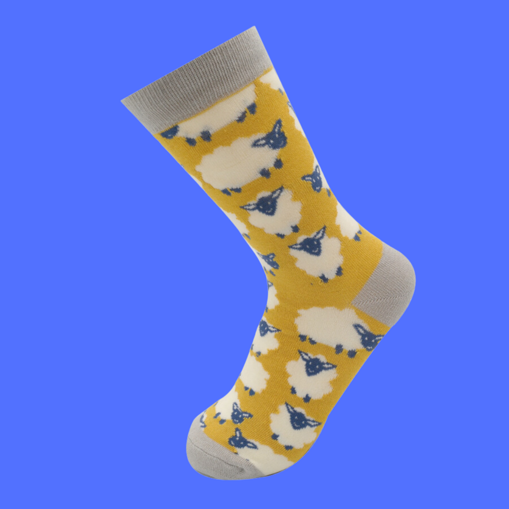 
                  
                    A pair of socks depicting happy sheep. Yellow legs, grey heel, toe and cuff.
                  
                