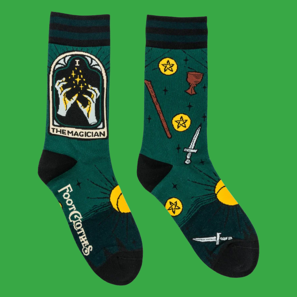 
                      
                        A pair of socks featuring the Magician tarot card. Green legs, black heel, toe and cuff. 
                      
                    