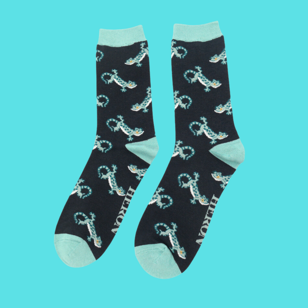 
                  
                    A pair of socks with a lizard pattern. dark green legs, turquoise heel, cuff and toe.
                  
                