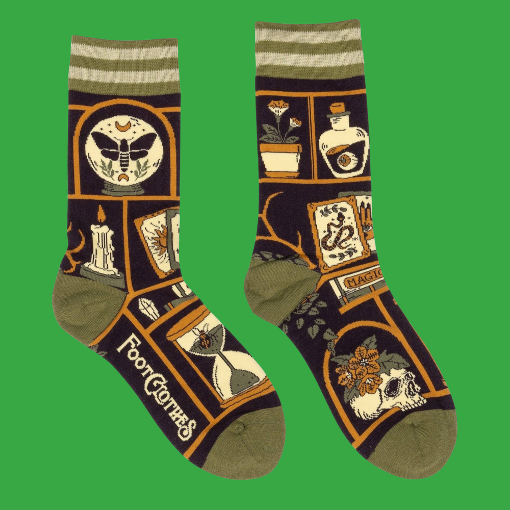 A pair of socks depicting a collection of odd objects. Brown legs, green, heel, toe and cuff. 