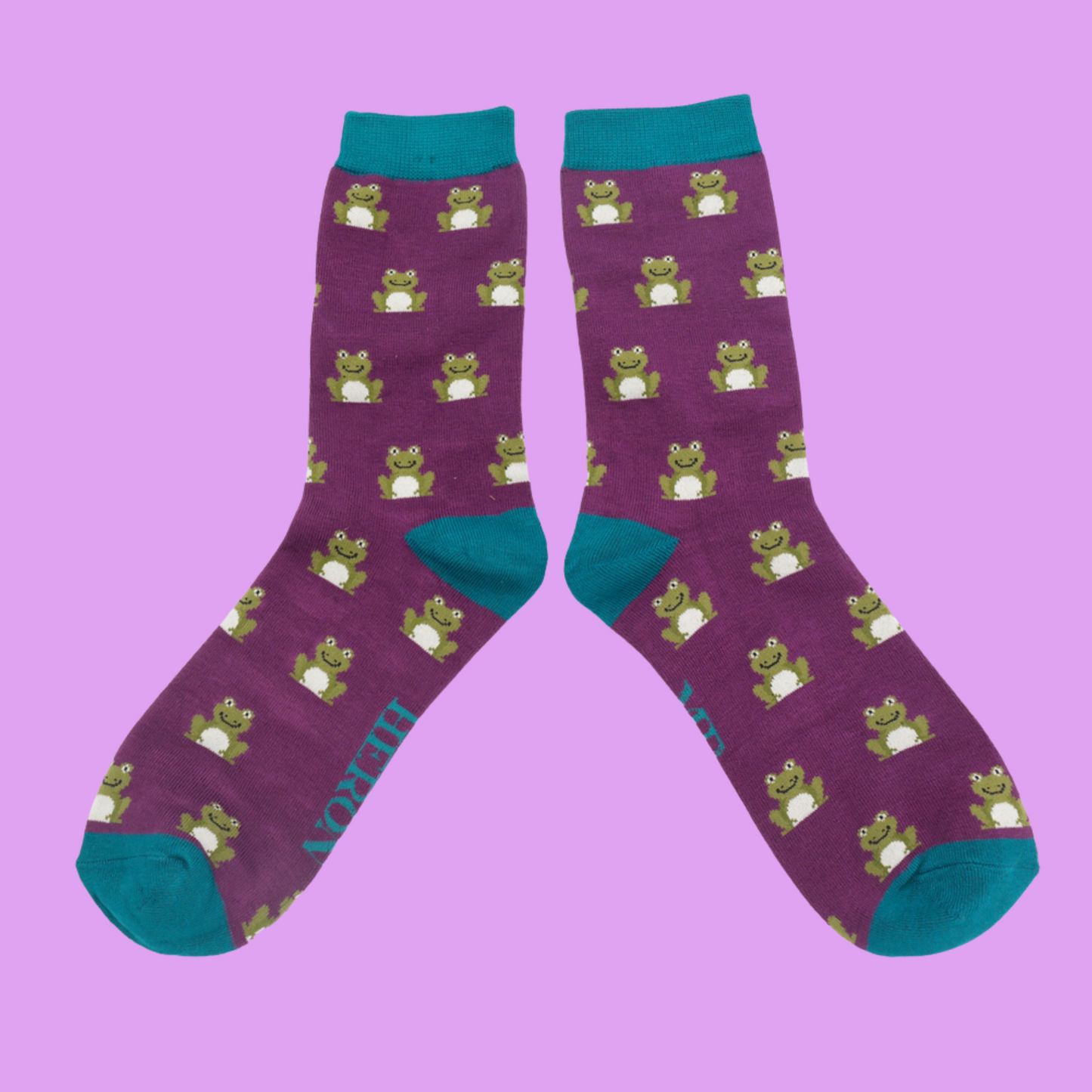 
                  
                    A pair of socks depicting happy frogs. Purple legs, teal cuff, heels and toes.
                  
                