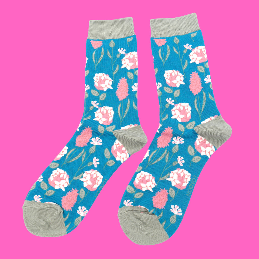 
                      
                        A pair of socks depicting British flowers and plants. Light blue legs, grey heel, cuff and toe.
                      
                    