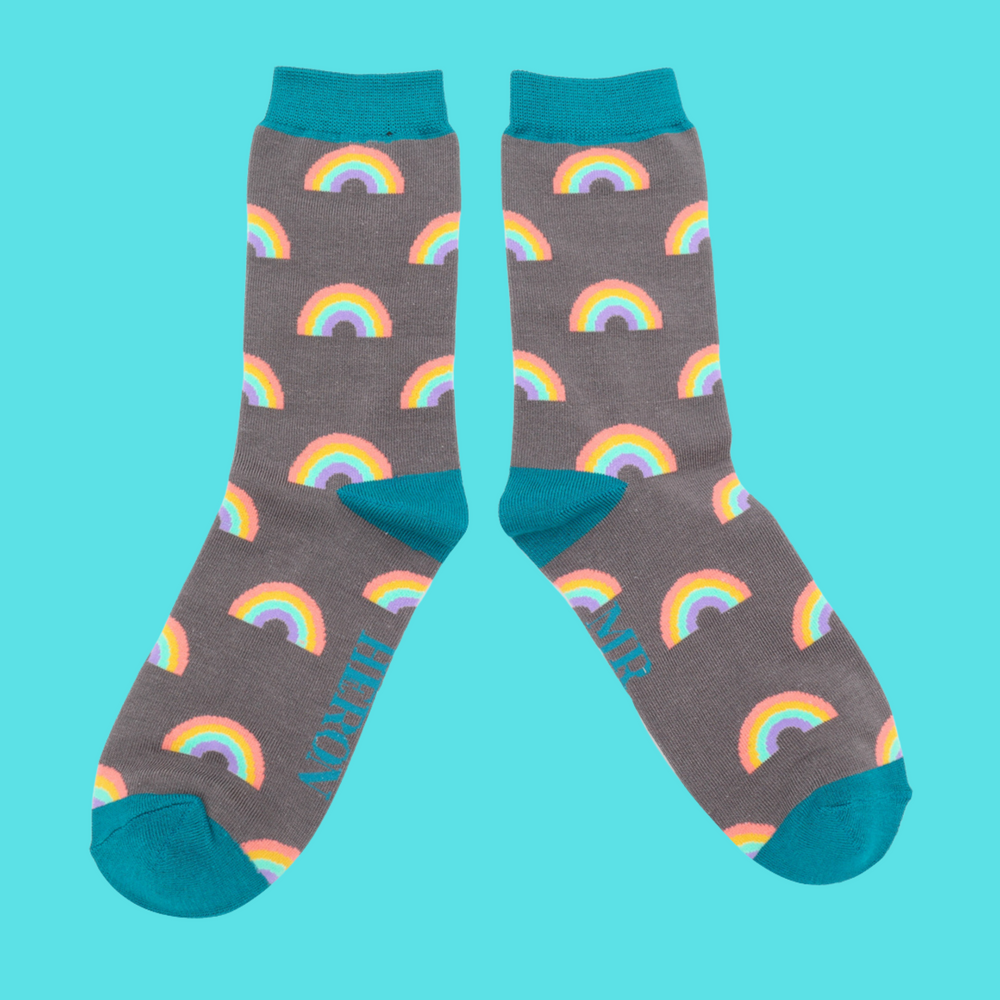 
                  
                    A pair of socks with a rainbow pattern. Grey blue legs, teal cuff, toe and heel.
                  
                