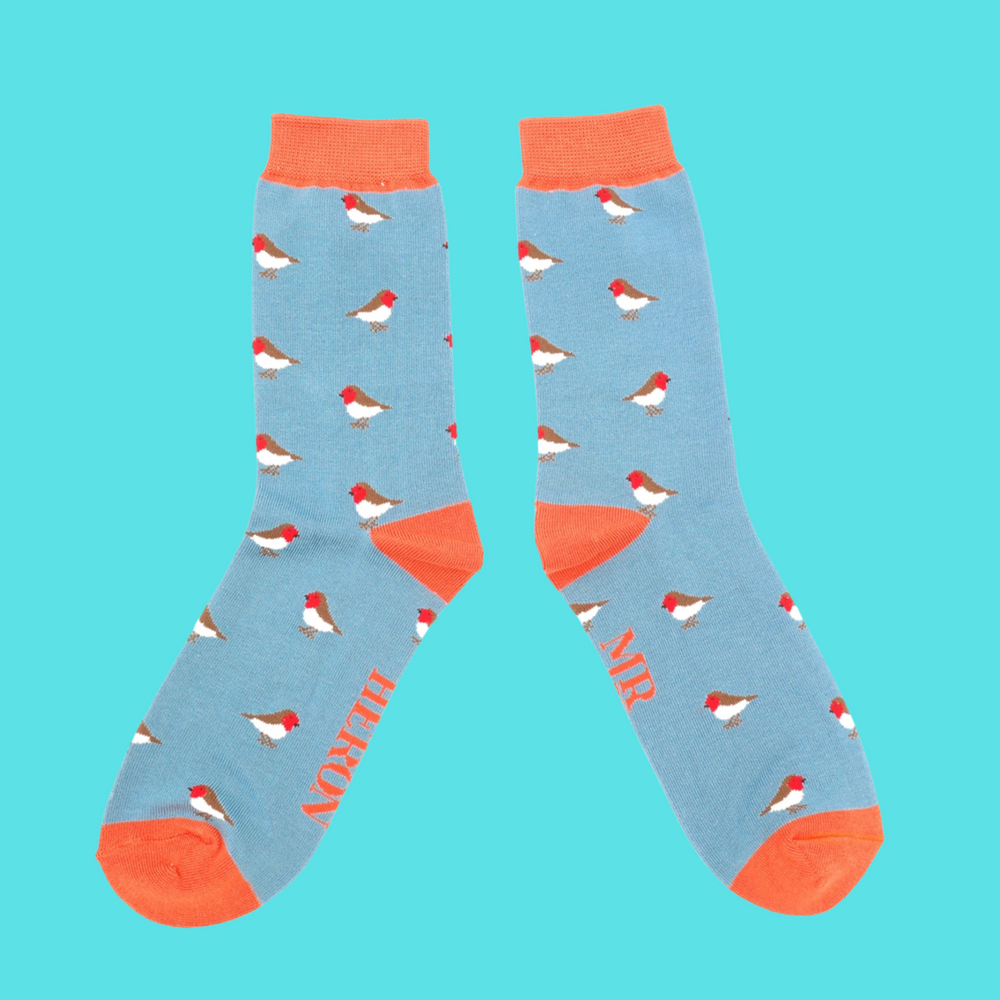 A pair of socks with a robin pattern. Blue legs, orange cuff, toe and heel.