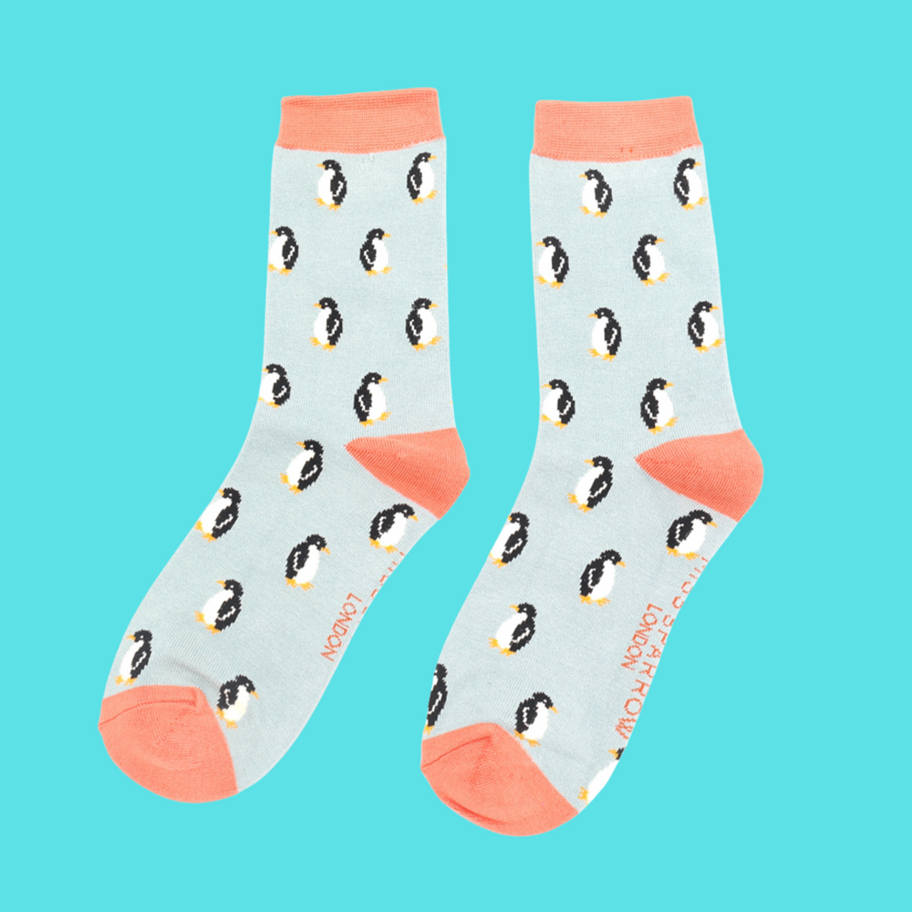 
                  
                    A pair of socks with a penguin pattern. Light blue legs, peach heel, cuff and toe.
                  
                